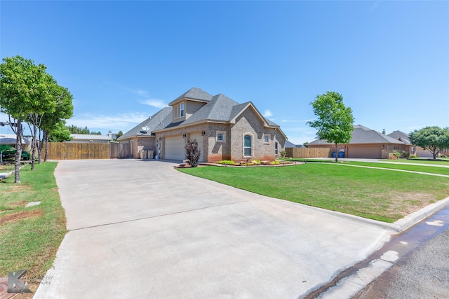 view of front of property featuring driveway, brick siding, fence, a front lawn, and a shingled roof