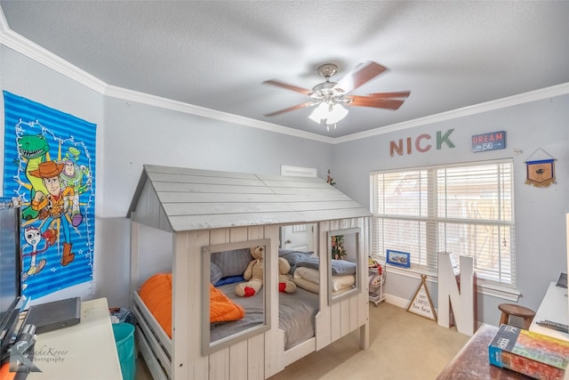 bedroom with carpet floors, a textured ceiling, a ceiling fan, baseboards, and ornamental molding