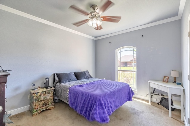 carpeted bedroom featuring baseboards, ornamental molding, and ceiling fan