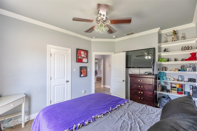 bedroom featuring baseboards, ornamental molding, a ceiling fan, and visible vents
