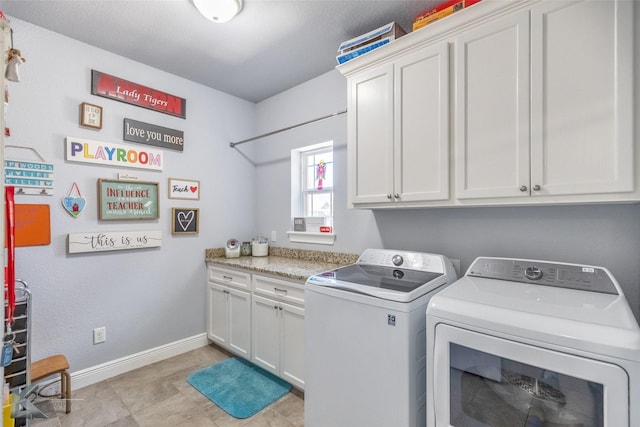 laundry area with separate washer and dryer, cabinet space, and baseboards