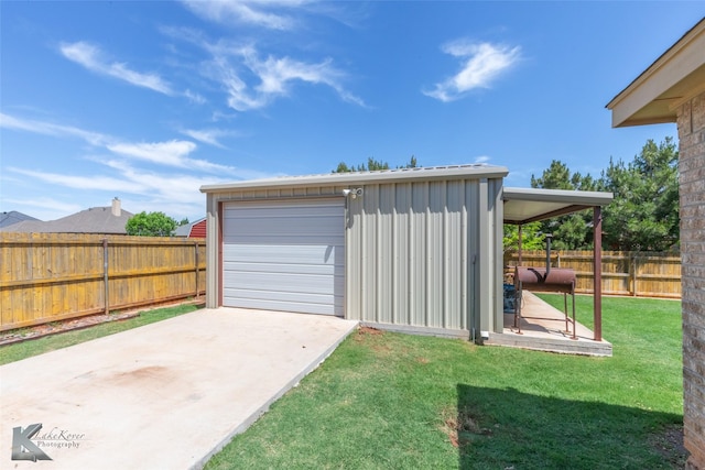 detached garage with fence and driveway