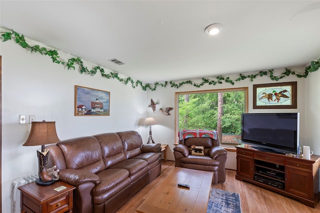 living room featuring visible vents and light wood-style floors