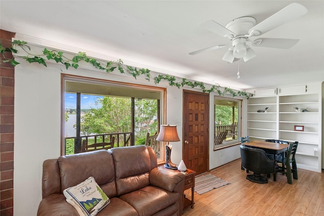living room with ceiling fan, a healthy amount of sunlight, and light wood finished floors