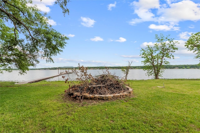 view of yard featuring a boat dock and a water view