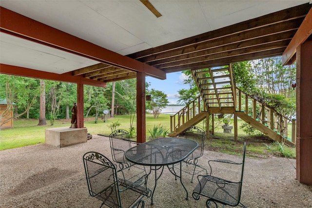 view of patio featuring stairs and outdoor dining space