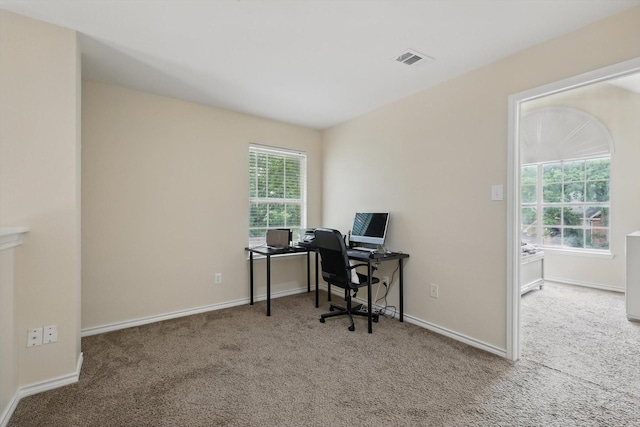 home office with carpet floors, baseboards, and visible vents