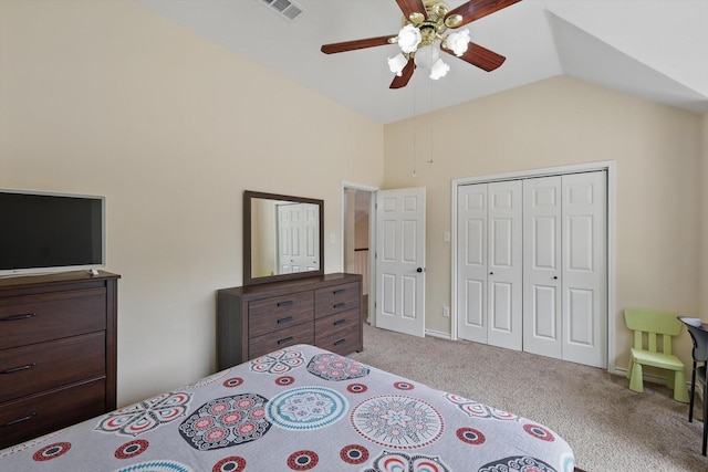 bedroom with a ceiling fan, visible vents, a closet, lofted ceiling, and carpet flooring