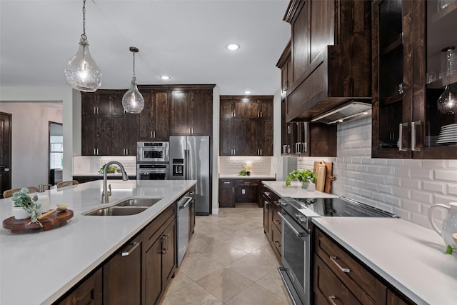 kitchen with light countertops, a sink, premium range hood, and stainless steel appliances