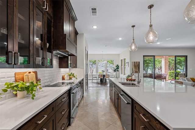 kitchen with visible vents, a sink, dark brown cabinets, and stainless steel appliances