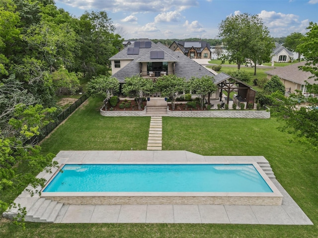outdoor pool featuring a yard, fence, and a patio area