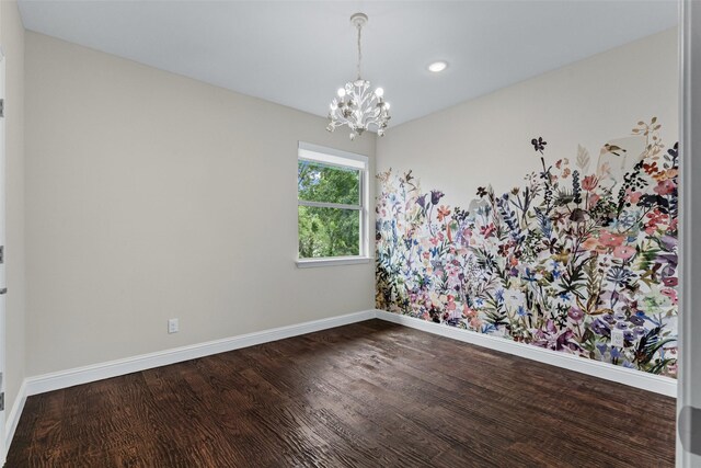 empty room with an inviting chandelier, baseboards, recessed lighting, and dark wood finished floors