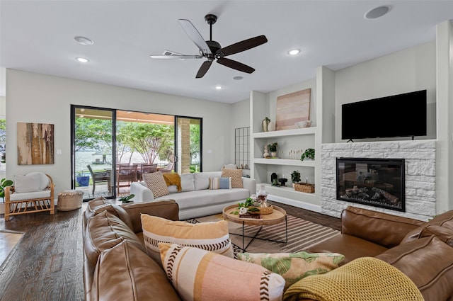 living area featuring recessed lighting, ceiling fan, wood finished floors, and a fireplace