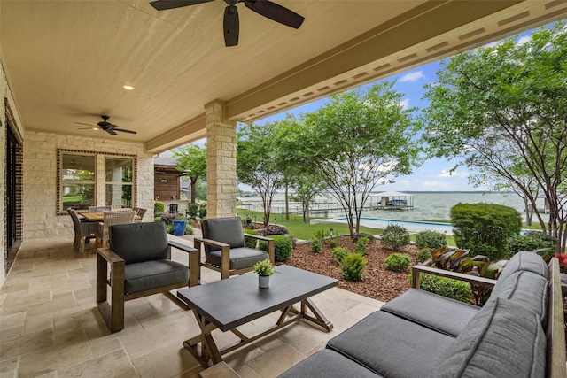 view of patio featuring outdoor dining area, a water view, ceiling fan, and outdoor lounge area