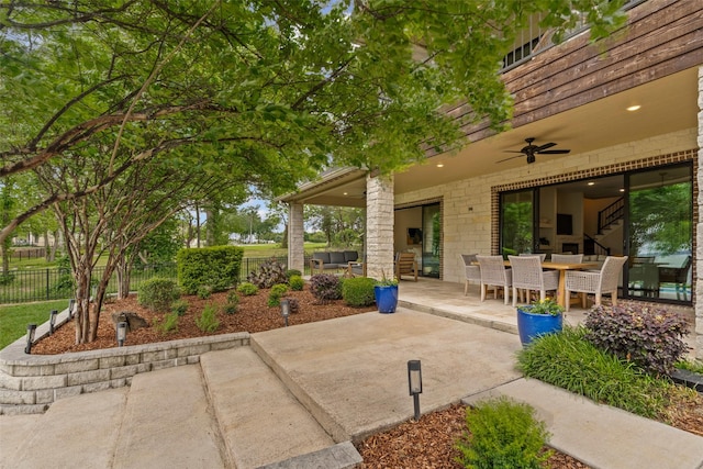 view of patio / terrace featuring a ceiling fan and fence