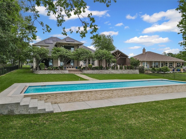 view of swimming pool featuring a fenced in pool, fence, and a yard