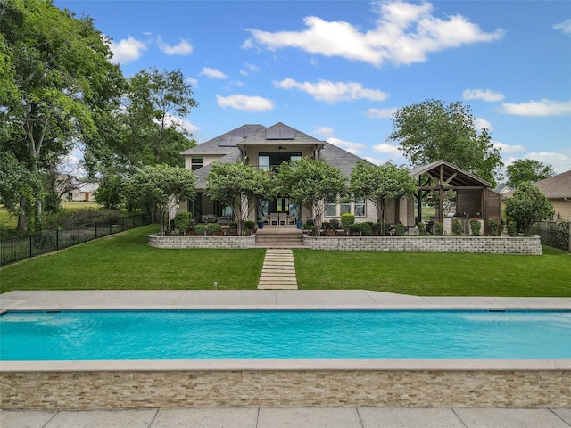 view of swimming pool featuring a yard, fence, and a fenced in pool