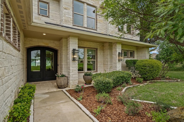 view of exterior entry with french doors and stone siding