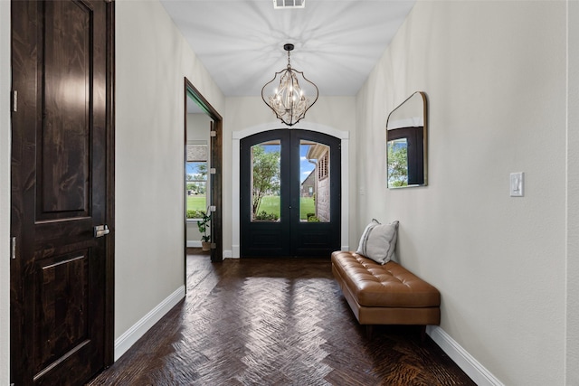 entrance foyer featuring baseboards, visible vents, french doors, and a notable chandelier