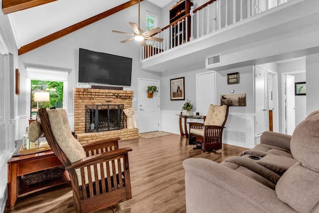 552 E Hideaway Ln, Hideaway, TX 75771 - living room featuring a fireplace, a ceiling fan, wood finished floors, a towering ceiling, and visible vents