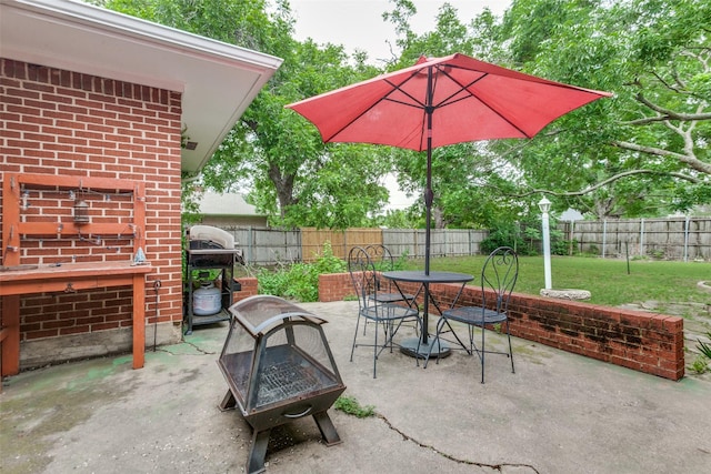 view of patio / terrace with outdoor dining area, a fenced backyard, and area for grilling