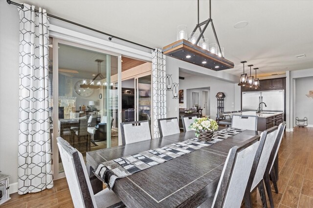 12225 Grosbeak Dr, Denton, TX 76207 - dining room featuring baseboards, an inviting chandelier, and wood finished floors