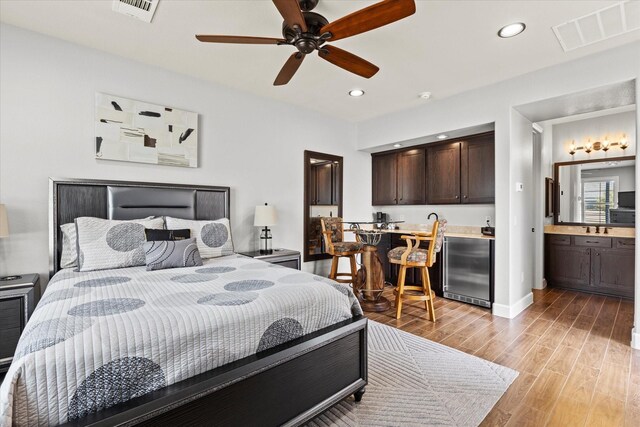 12225 Grosbeak Dr, Denton, TX 76207 - bedroom with visible vents, recessed lighting, light wood finished floors, wet bar, and stainless steel built in refrigerator