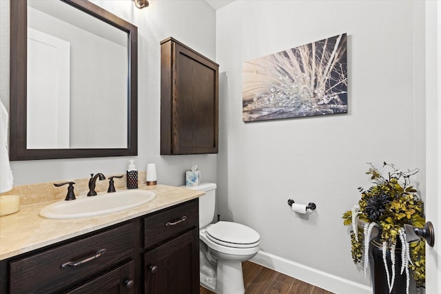 12225 Grosbeak Dr, Denton, TX 76207 - bathroom with baseboards, wood finished floors, toilet, and vanity