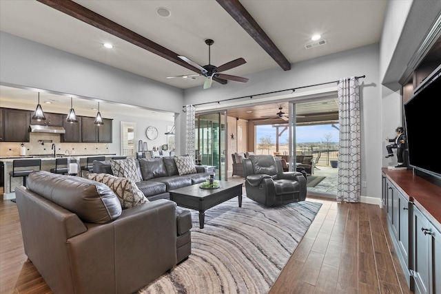 12225 Grosbeak Dr, Denton, TX 76207 - living area featuring visible vents, beam ceiling, baseboards, ceiling fan, and dark wood-type flooring