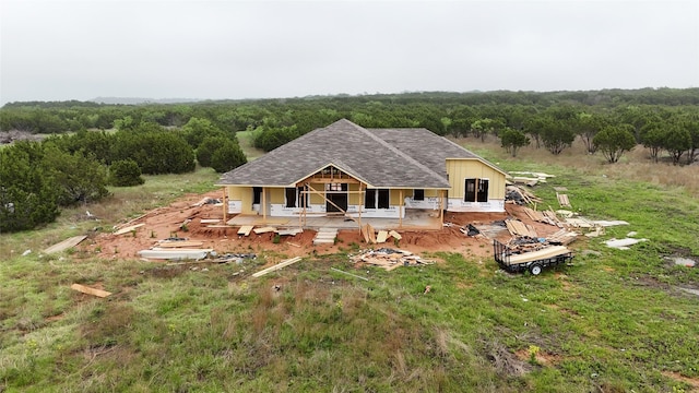 birds eye view of property with a wooded view