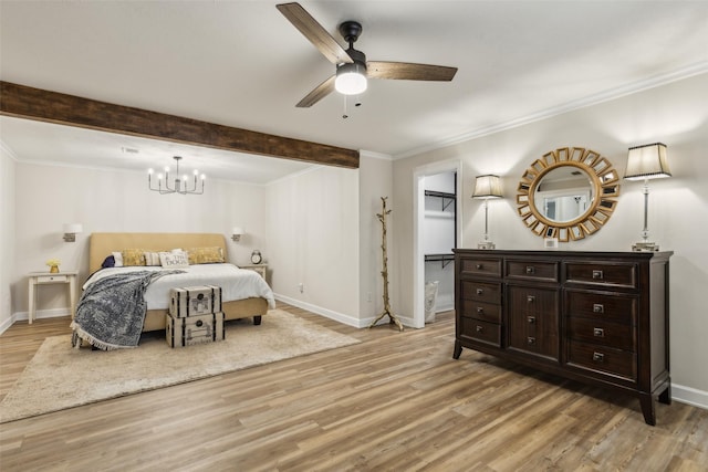 bedroom featuring light wood-type flooring, beam ceiling, baseboards, a spacious closet, and ornamental molding