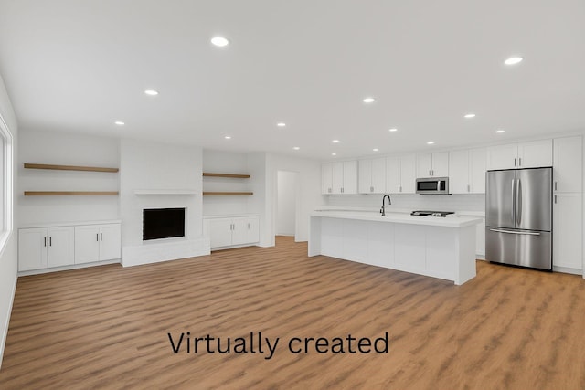 kitchen with recessed lighting, light countertops, white cabinetry, light wood finished floors, and stainless steel appliances