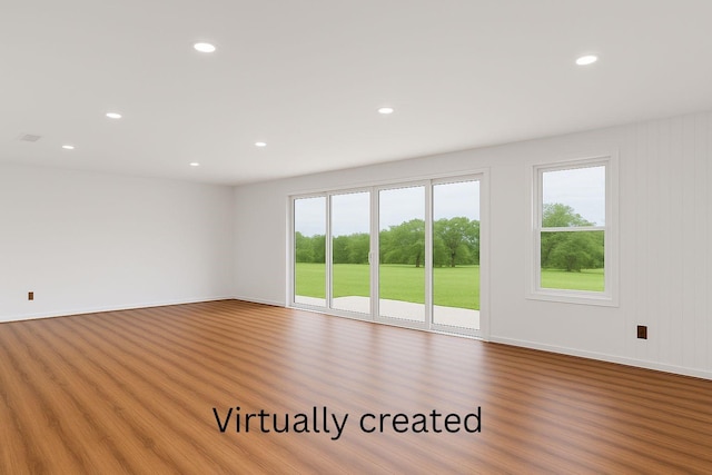 unfurnished room with baseboards, recessed lighting, and wood finished floors