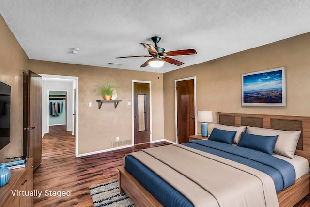 bedroom with ceiling fan, baseboards, visible vents, and wood finished floors