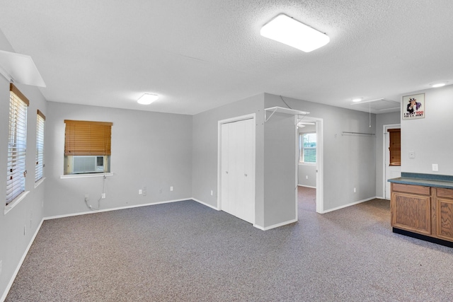 basement featuring baseboards, carpet, and cooling unit