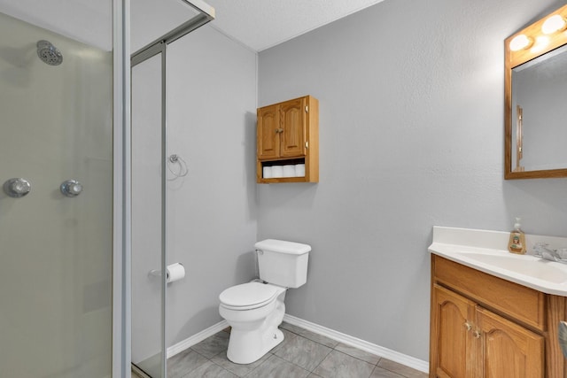 full bath featuring a shower stall, vanity, baseboards, tile patterned floors, and toilet