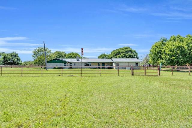 view of yard with fence and a rural view