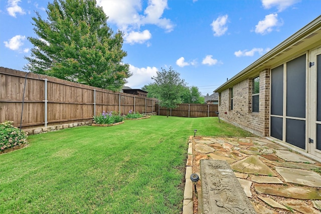 view of yard with a fenced backyard
