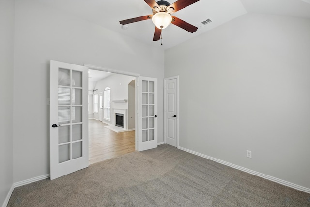 3512 Kales Ln, Flower Mound, TX 75022 - spare room featuring a ceiling fan, french doors, visible vents, vaulted ceiling, and carpet flooring