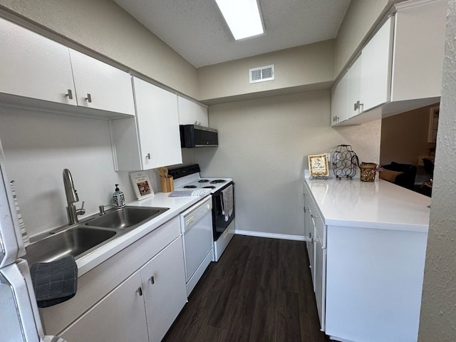 kitchen featuring dishwasher, stainless steel microwave, dark wood-type flooring, visible vents, and range with electric stovetop