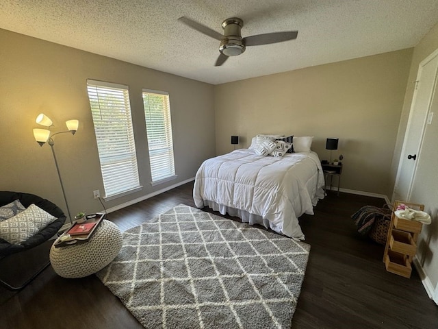 bedroom with baseboards, a ceiling fan, a textured ceiling, and wood finished floors