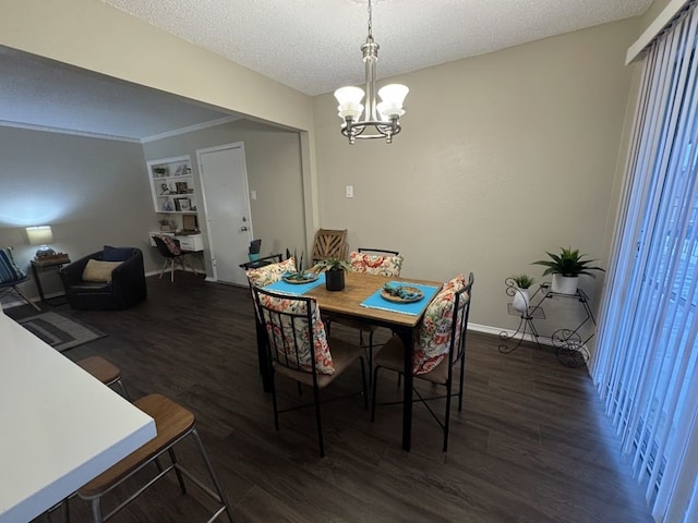 dining area featuring a textured ceiling, a notable chandelier, and dark wood finished floors