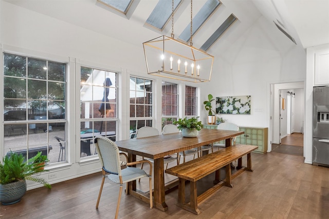 dining room featuring beamed ceiling, high vaulted ceiling, a chandelier, and wood finished floors