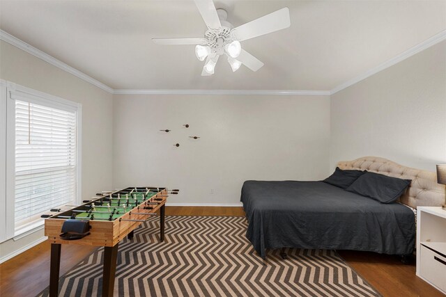 bedroom featuring crown molding, multiple windows, and wood finished floors