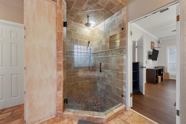 full bathroom featuring crown molding, visible vents, and a stall shower