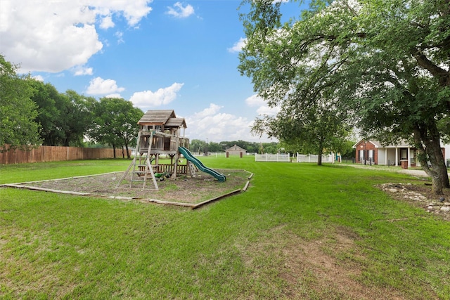 view of jungle gym featuring fence and a yard