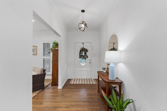 foyer featuring ornamental molding and wood finished floors