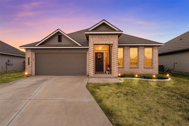 single story home featuring concrete driveway, brick siding, a front yard, and a garage