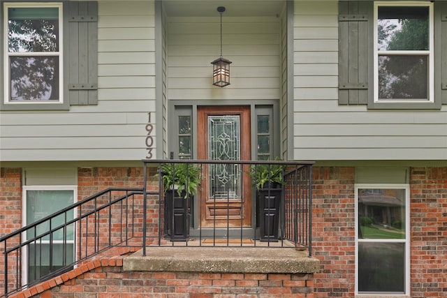 property entrance featuring brick siding