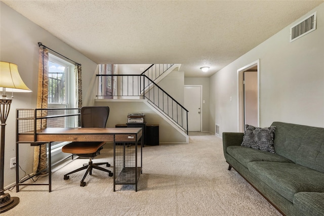 office area featuring baseboards, carpet, a textured ceiling, and visible vents
